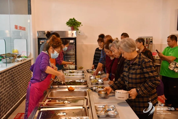 老人們在幾江街道南門社區帥鄉幸福食堂排隊打菜。江津福彩供圖